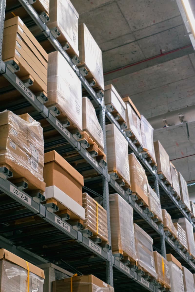 Cardboard cartons stacked on tall storage racking